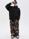 Pantalon de ski ample et fluide pour femme, en polaire imitation sherpa avec fermeture éclair intégrale et genoux renforcés.