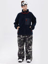 Pantalon de ski ample et fluide pour femme, en polaire imitation sherpa avec fermeture éclair intégrale et genoux renforcés.