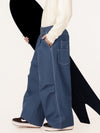 Pantalon de travail en denim brut à rivets pour homme, coupe oversize, avec double poche arrière.