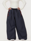 Pantalon de ski freestyle extra ample Hyper Flux pour femme, fermeture éclair latérale et empiècement graffiti.