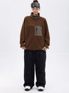 Pantalon de ski ample et fluide pour femme, en polaire imitation sherpa avec fermeture éclair intégrale et genoux renforcés.