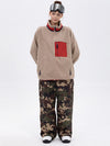 Pantalon de ski ample et fluide pour femme, en polaire imitation sherpa avec fermeture éclair intégrale et genoux renforcés.