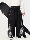 Pantalon de jogging ample de ski pour homme, style graffiti, avec empiècements colorés et bandes réfléchissantes.