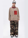 Pantalon de ski ample et fluide pour femme, en polaire imitation sherpa avec fermeture éclair intégrale et genoux renforcés.