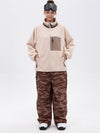 Pantalon de ski ample et fluide pour femme, en polaire imitation sherpa avec fermeture éclair intégrale et genoux renforcés.