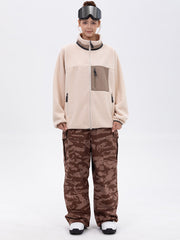 Pantalon de ski ample et fluide pour femme, en polaire imitation sherpa avec fermeture éclair intégrale et genoux renforcés.
