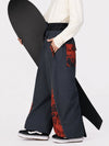 Pantalon de jogging ample de ski pour homme, style graffiti, avec empiècements colorés et bandes réfléchissantes.